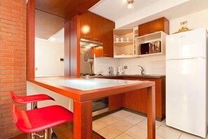 Full-size fridge, microwave, coffee/tea maker, cookware/dishes/utensils