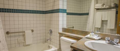 A bathroom with a bathtub, toilet, and sink.