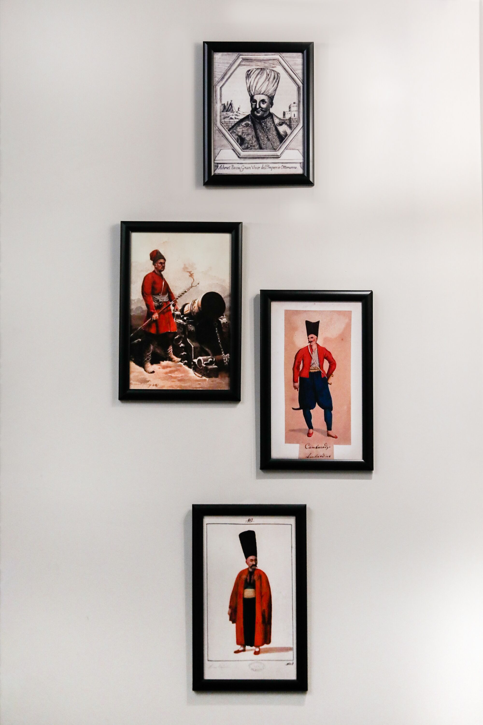 Three framed artworks on a wall.