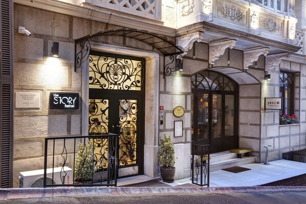 A hotel entrance with ornate ironwork, a sign reading "The Story Hotel," and a plaque indicating the hotel's name. - The Story Hotel Pera (Istanbul)