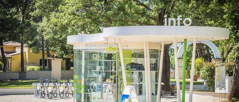 A modern kiosk with a glass front and a sign that reads "info".