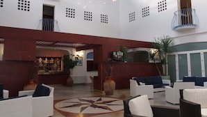 A spacious lobby with a central bar area, seating arrangements, and a decorative ceiling light fixture. - Maritalia Hotel Club Village - All Inclusive (Peschici)
