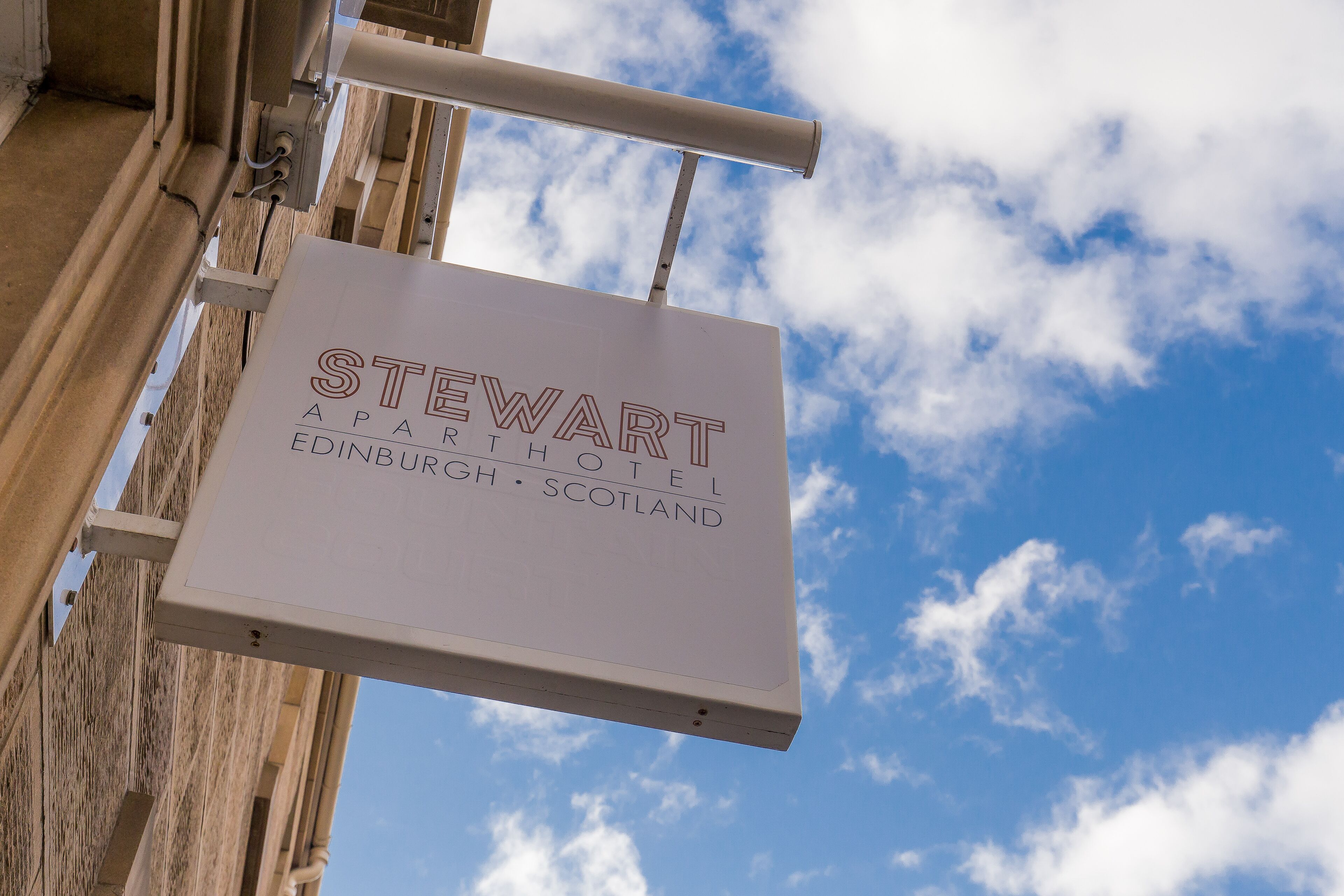 A sign for Stewart Apartments Hotel in Edinburgh, Scotland.