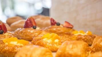 A variety of pastries with fruit toppings.