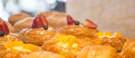 A variety of pastries with fruit toppings.