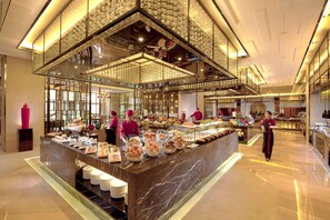 A buffet area with a marble counter, staff in uniforms, and a decorative ceiling. - Hilton Guangzhou Baiyun-Canton Fair Free Shuttle Bus Service and Free Registration (Guangzhou)