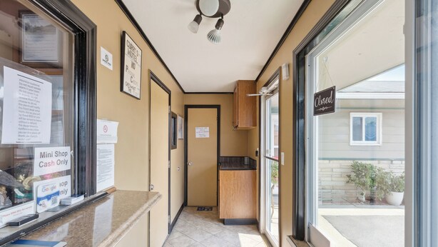 A hotel lobby with a reception desk, a mini shop, and a closed sign.