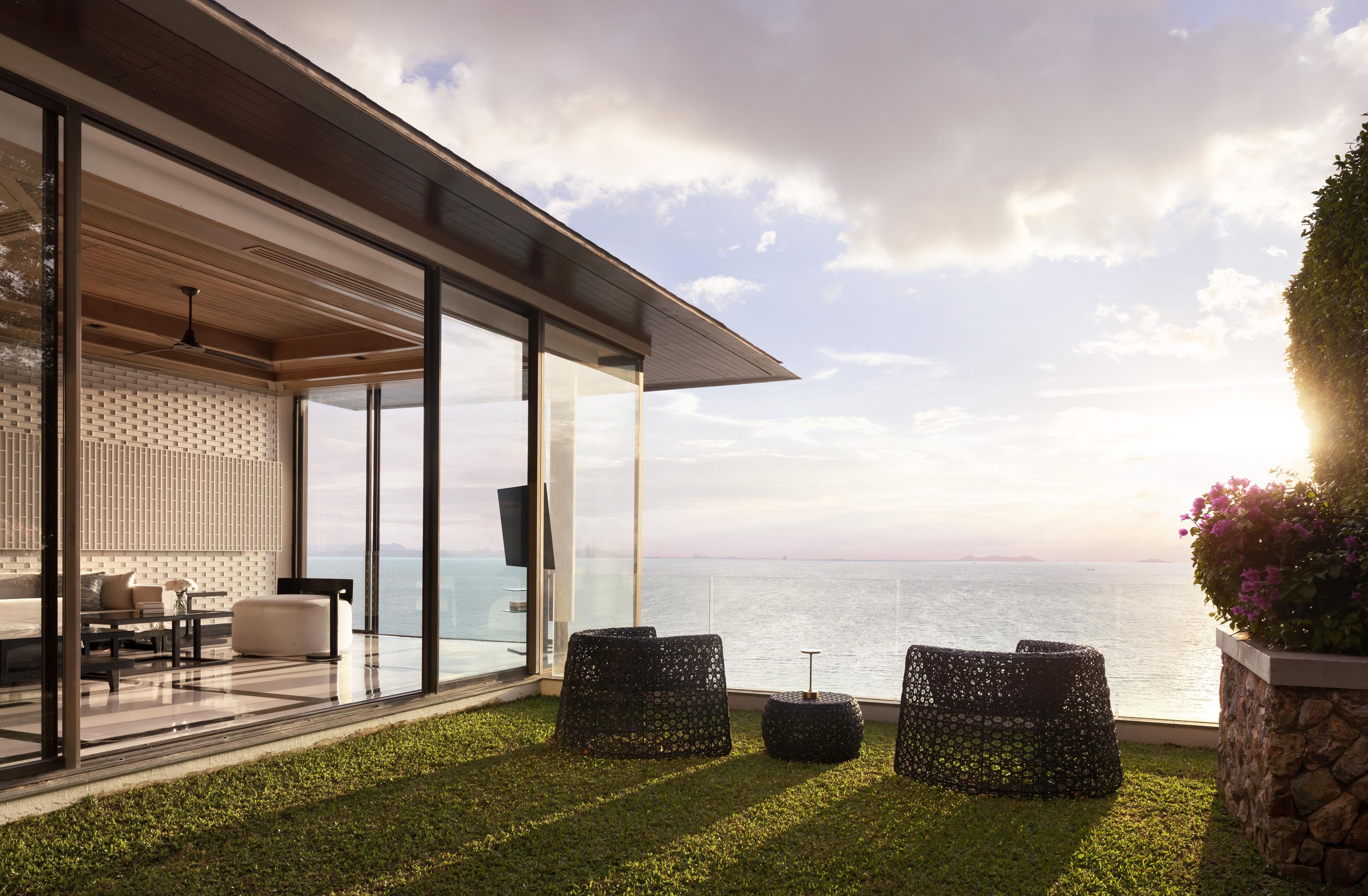 A modern outdoor seating area with a view of the sea.