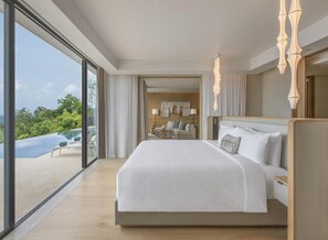A modern hotel room with a large bed, a view of a swimming pool, and a balcony.