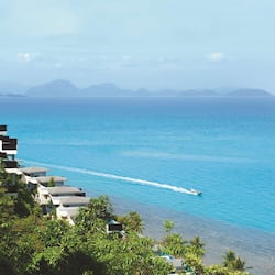 Enjoy serene views of the calm sea and distant mountains from this beachfront hotel.