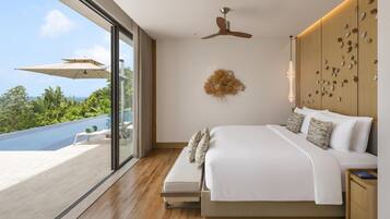 A modern bedroom with a large bed, a ceiling fan, a wall-mounted light fixture, and a view of a pool.