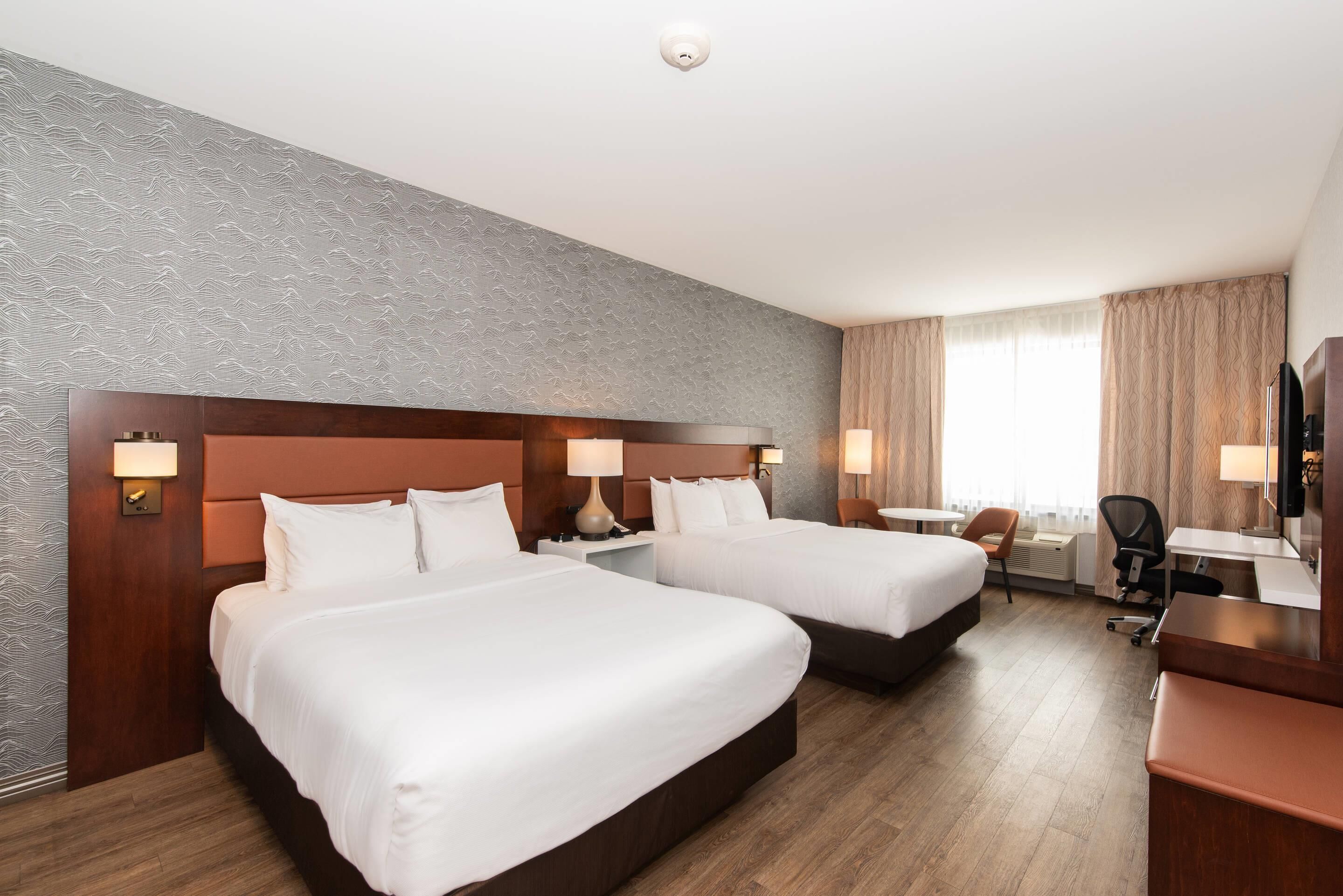 Premium bedding, pillow-top beds, desk, laptop workspace