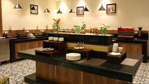 A modern kitchen with a central island, pendant lighting, and various kitchen appliances. - Days Hotel by Wyndham Neemrana Jaipur Highway (Neemrana)