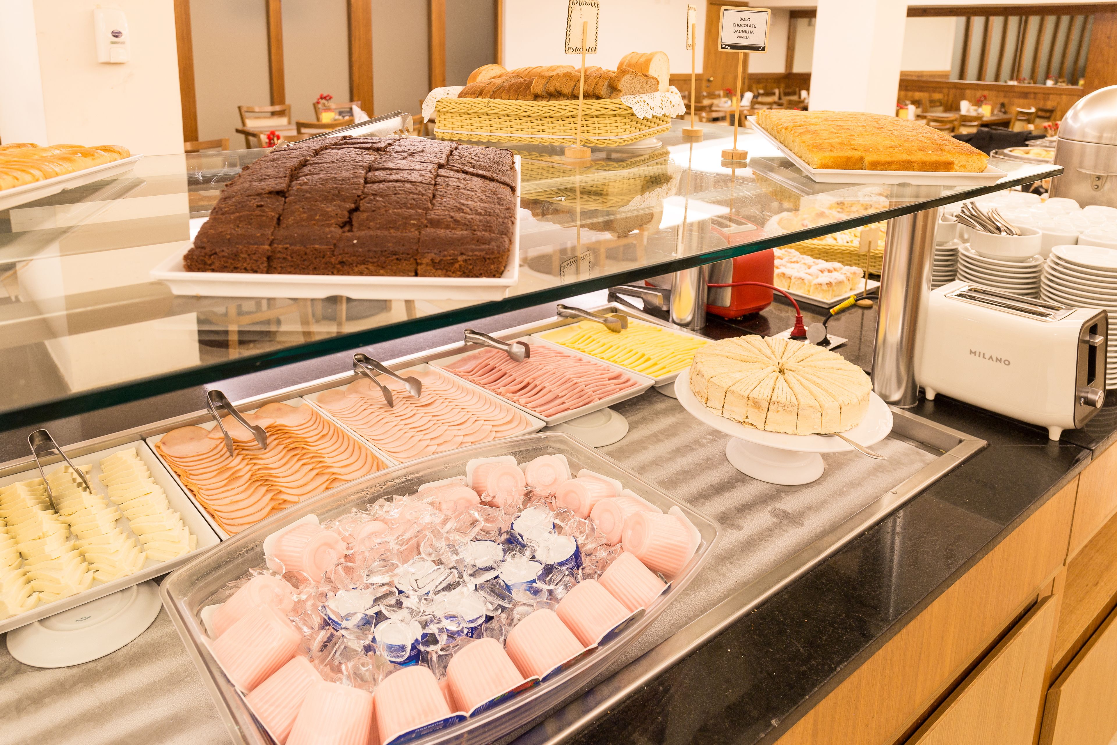 A buffet with various food items including cakes, pastries, and desserts.