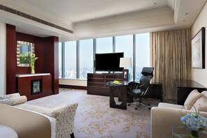A hotel room with a large window, a flat-screen TV, a desk with a chair, and a sofa. - Intercontinental Wuxi by IHG (Wuxi)