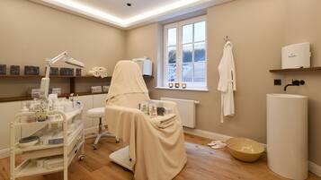 Guest rooms offer a clean and modern space with a white examination chair, medical supplies, and a large window.