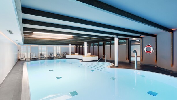 An indoor swimming pool with a modern design, featuring a curved edge, multiple seating areas, and a lifebuoy on the wall. - Relais & Châteaux Landhaus Stricker (Sylt)