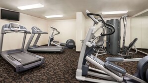 A hotel fitness center with treadmills, elliptical machines, and weight equipment. - Travelodge by Wyndham McAlester (McAlester)