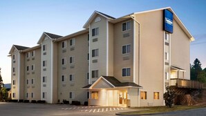 A multi-story hotel with a flat roof, a covered entrance, and a sign indicating it is a Fairfield Inn & Suites. - Travelodge by Wyndham McAlester (McAlester)