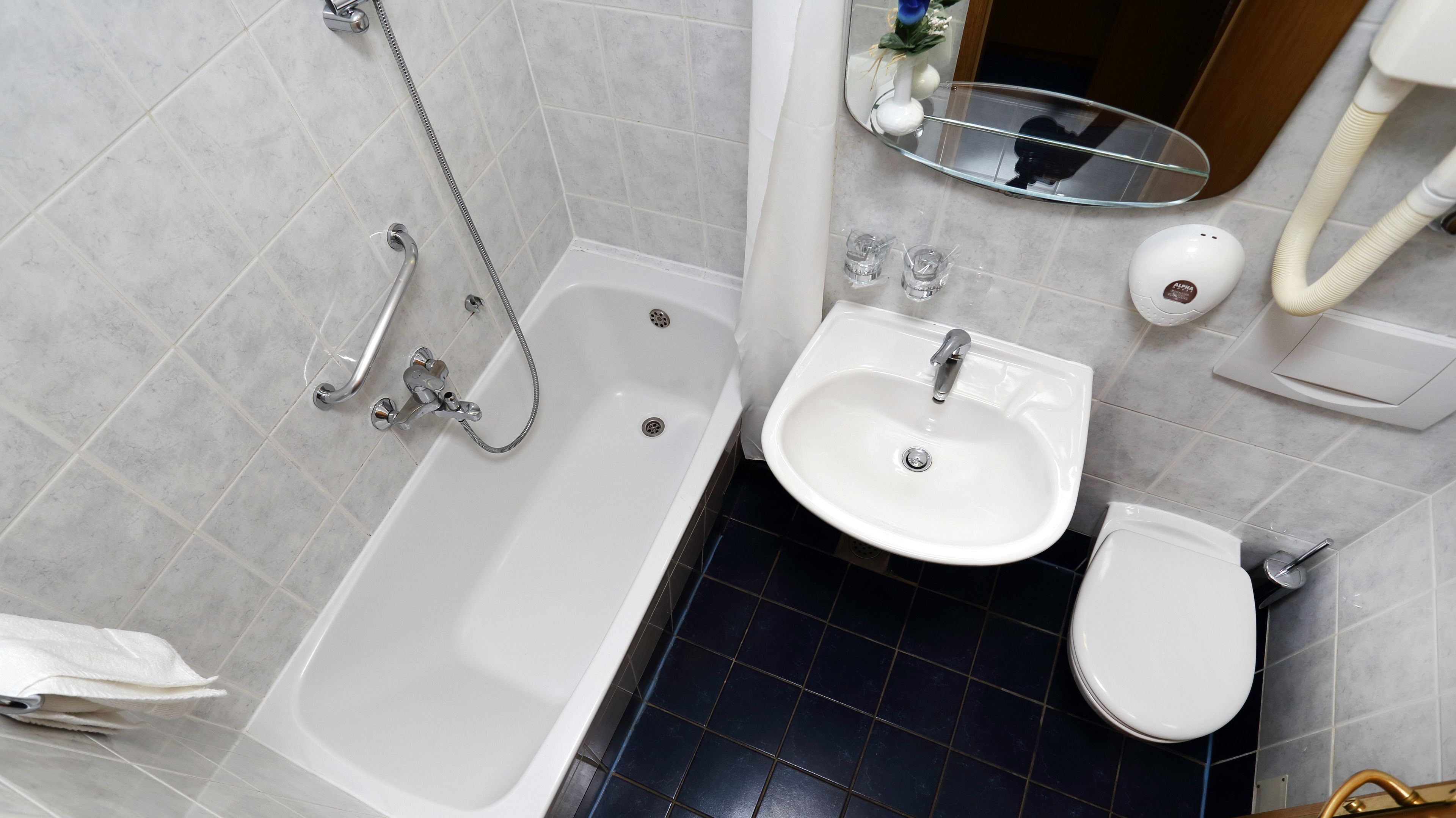 A bathroom with a bathtub, sink, and toilet.