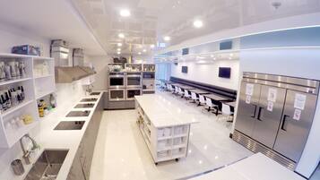 A modern kitchen with stainless steel appliances, white countertops, and a central island.