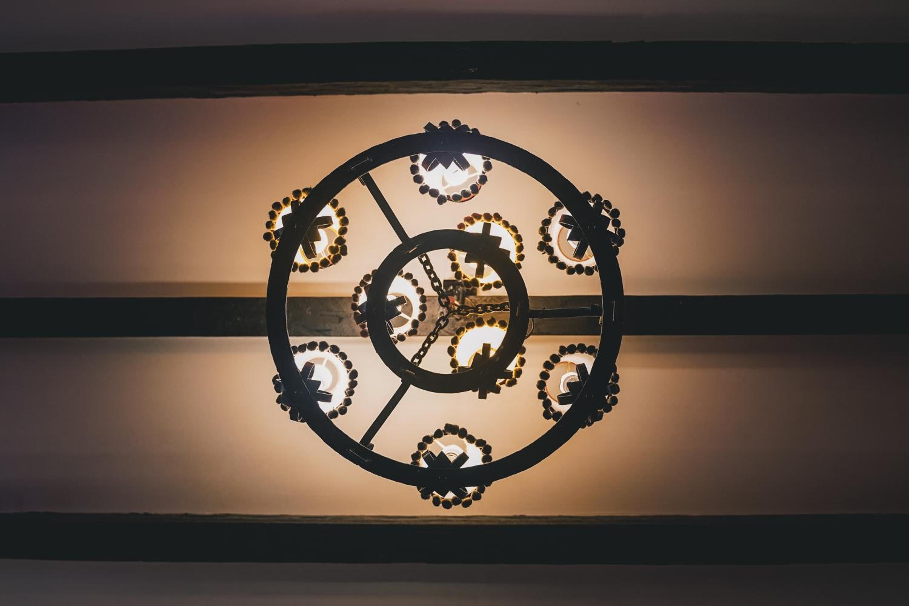 A wall-mounted clock with a circular design and multiple dials.