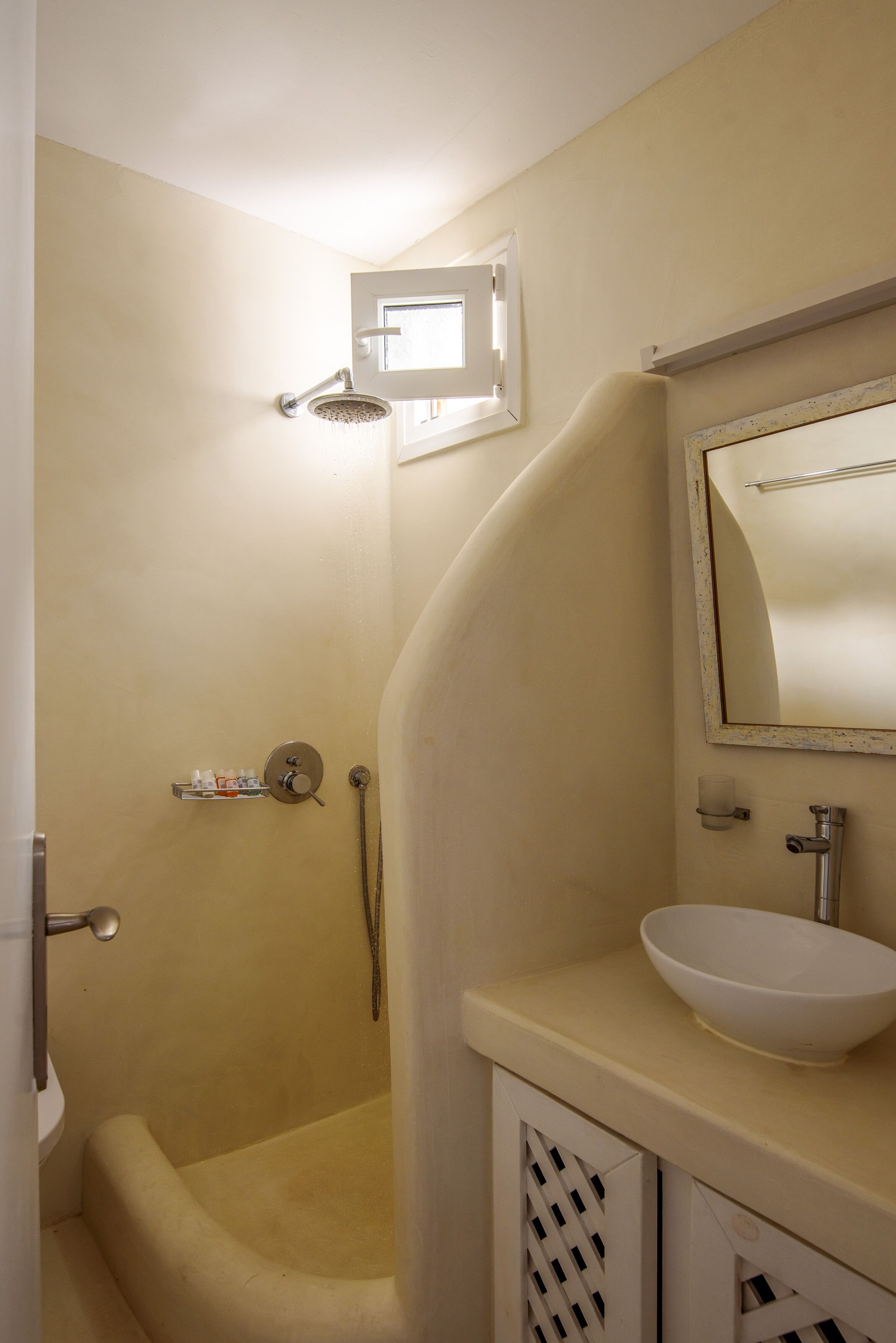 A bathroom with a bathtub, a shower, a sink, and a mirror.