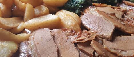 A plate of sliced roast beef, roasted potatoes, and steamed broccoli.