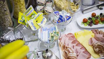 A table with various food items including cheese, meats, and condiments.