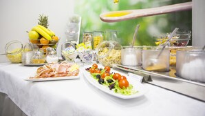 A buffet table with various food items and condiments. - Hotel More (Split)