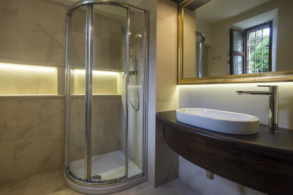 junior suite | bathroom | shower, rainfall showerhead, hair dryer, slippers