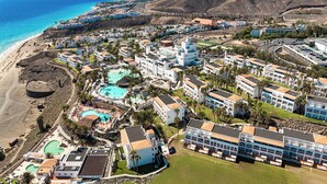 A coastal resort with multiple buildings, a swimming pool, and a beach. - Club Jandía Princess - All Inclusive (Pajara)