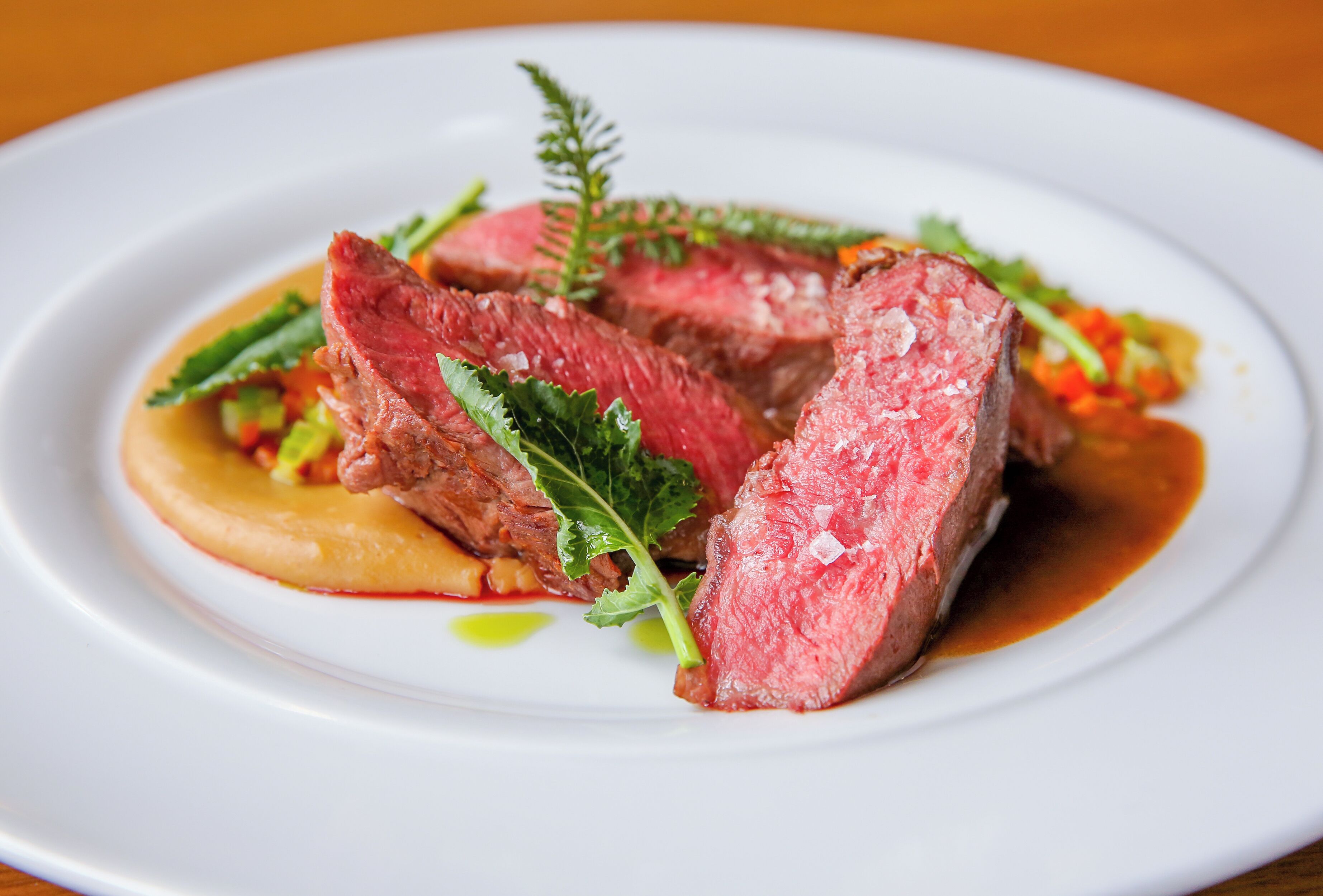 A plate of food with steak and vegetables.