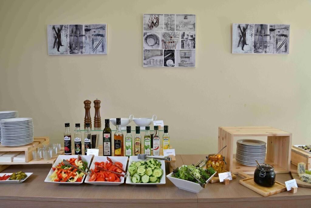 A buffet setup with various dishes, condiments, and a selection of beverages.