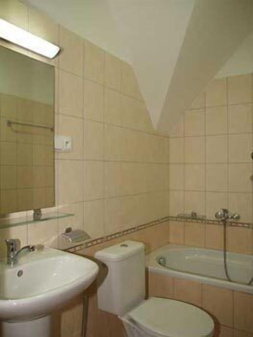 A bathroom with a sink, toilet, and bathtub.