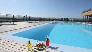 Outdoor pool, open 10 AM to 11 PM, pool loungers