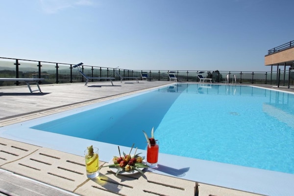 Outdoor pool, open 10 AM to 11 PM, pool loungers