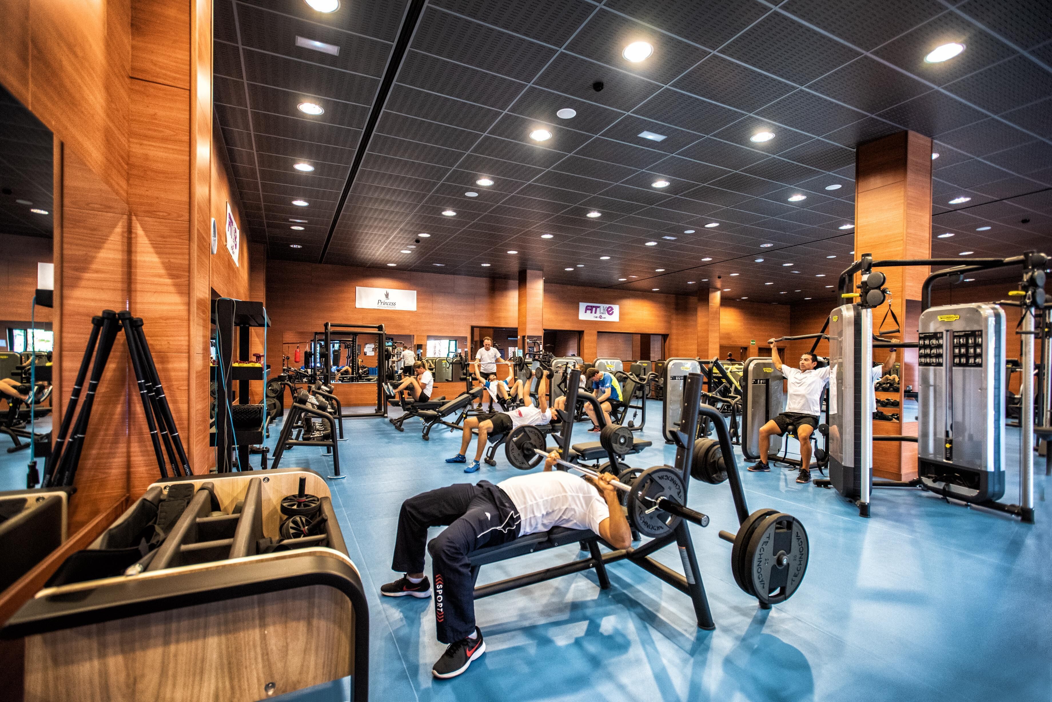 A gym with various exercise equipment, including weight machines and free weights.