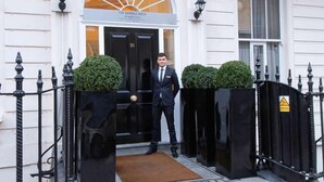 A man in a suit standing at the entrance of The Marble Arch hotel. - Park Grand Mayfair (London)
