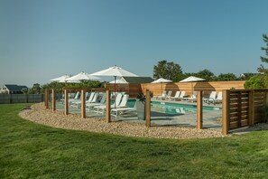 Een seizoensgebonden buitenzwembad en parasols bij het zwembad