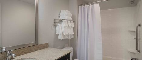 A modern bathroom with a sink, toilet, and shower.