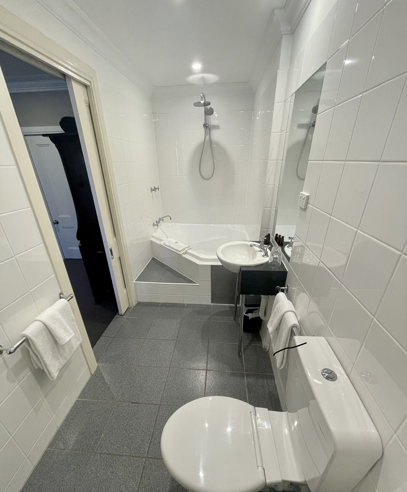A bathroom with a toilet, sink, and bathtub.