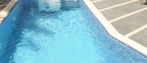 Outdoor pool, open 9:00 AM to 6:00 PM, pool loungers