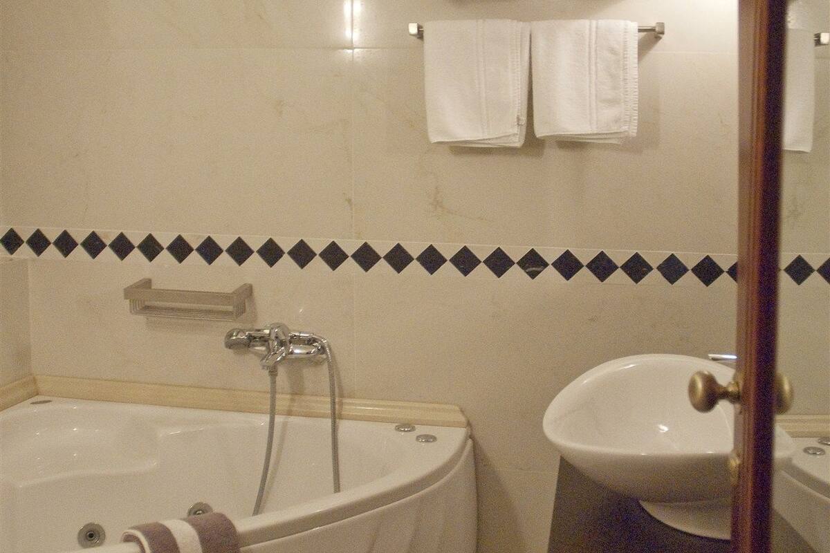 designer toiletries, hair dryer, bathrobes, slippers