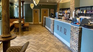 A bar area with a herringbone floor, wooden pillars, and a counter with a sign reading "BAR". - The Spa Hotel (Saltburn-by-the-Sea)