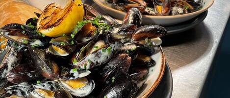 A seafood dish with mussels, lemon, and herbs.