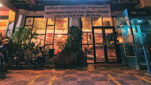 The exterior of the Diamond Palace Hotel with a signboard, entrance, and surrounding area including a motorbike and potted plants. - Diamond Palace Hotel (Phnom Penh)