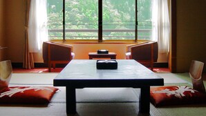 A room with a large window, a table, two chairs, and a cushion. - Onyado Toho（ORIX HOTELS & RESORTS） (Aizuwakamatsu)