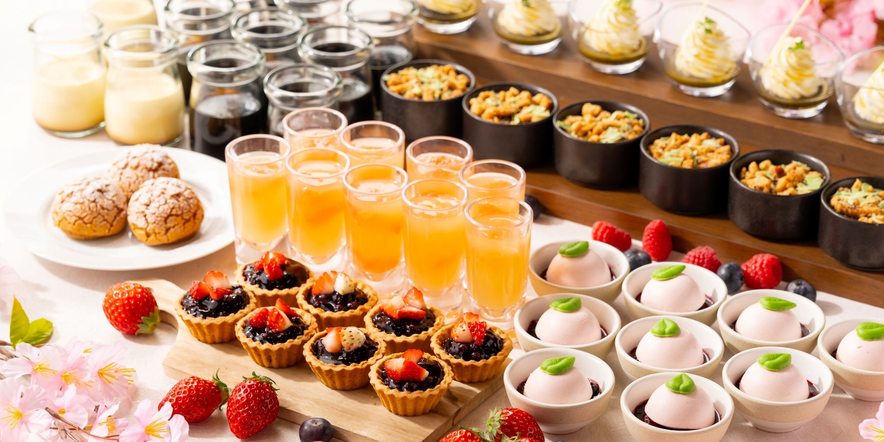 A variety of desserts and beverages on a table.