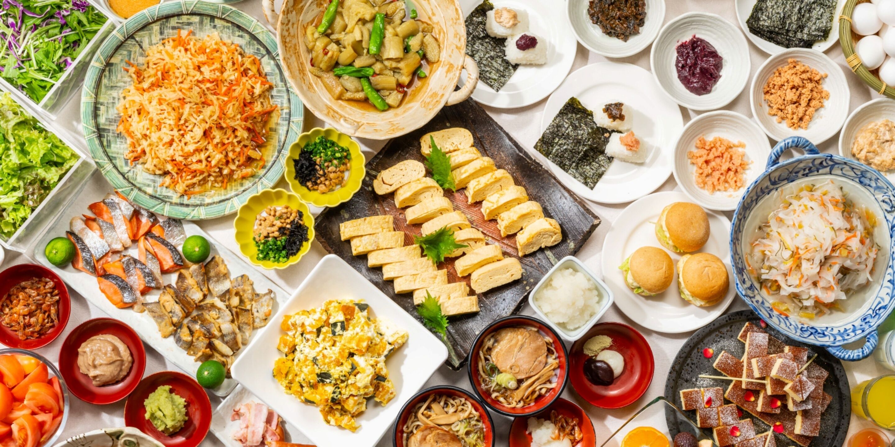 A variety of dishes and food items arranged on a table.